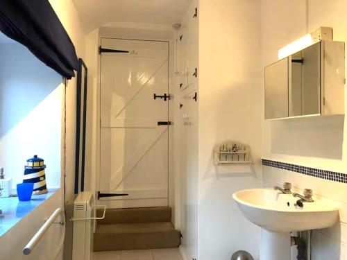 a white bathroom with a sink and a shower at 1 Bed in Ampleforth oc-b34674 in Ampleforth
