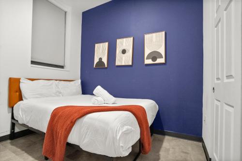 a bedroom with a bed with a blanket on it at CozySuites at William in Pittsburgh