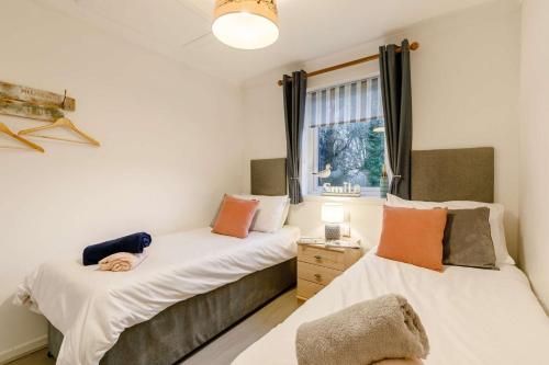 two beds in a room with a window at 2 Bed in Penzance oc-m27232 in Gulval
