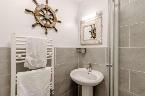 a bathroom with a sink and a toilet and a shower at 2 Bed in Penzance oc-m27232 in Gulval