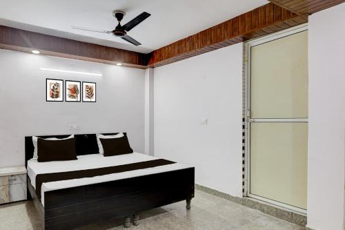 a bedroom with a bed and a ceiling fan at Collection O Sector 18 Noida Formerly True Residency in Okhla
