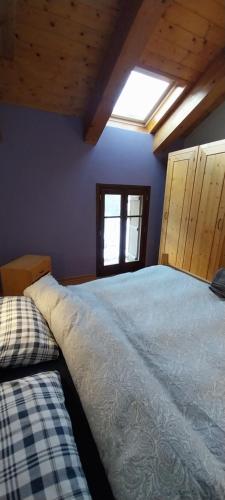 a bedroom with a large bed and a window at Rifugio Alevé in Castello