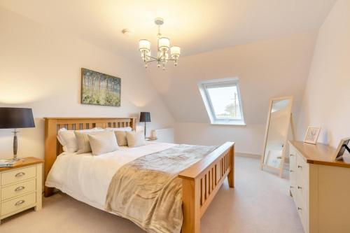 a bedroom with a large bed and a chandelier at 2 Bed in Duddlestone oc-q34588 in Duddlestone