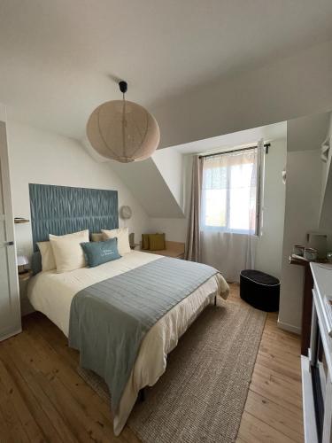 a bedroom with a large bed and a window at Maison Le Beaulieu in Vichy