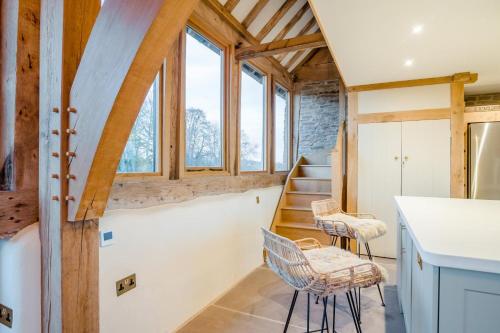 a kitchen with two chairs and stairs in a house at 3 Bed in Dulas oc-g34082 in Longtown