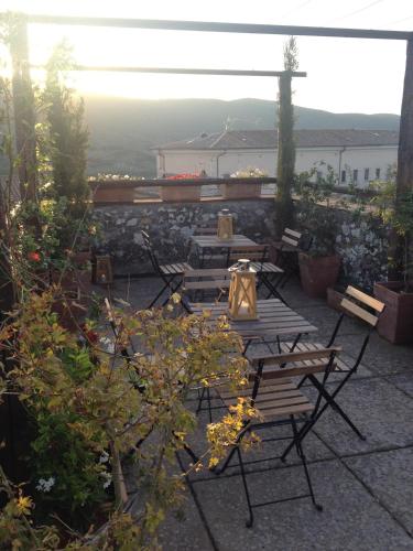 a patio with chairs and a table with a view at La Corte Di Alice in Lugnano in Teverina