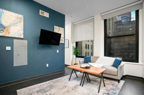 a living room with a couch and a table at CozySuites at William in Pittsburgh