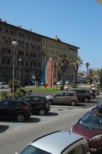 a parking lot with cars parked in front of a large building at 211 Underground in Viareggio