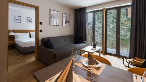 a living room with a couch and a table at BARTAL APARTMENTS - Špindlerův Mlýn in Špindlerův Mlýn