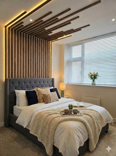 a bedroom with a large bed with a large window at Your Holiday & Home Brighton in Brighton & Hove