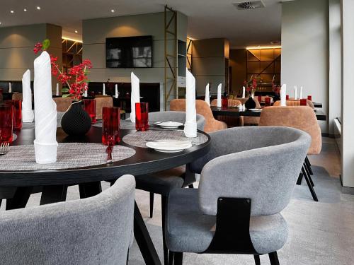 a dining room with a table and chairs at Ramada by Wyndham Essen in Essen