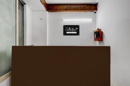a black sign on a wall in a room at Collection O Sector 18 Noida Formerly True Residency in Okhla