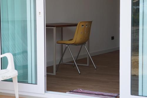 a chair sitting next to a desk in a room at Travellers Palm in Koh Phangan