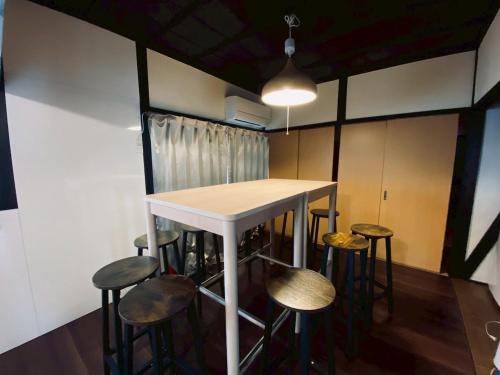 a table and some stools in a room at Katata Biwa House in Otsu