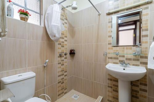 a bathroom with a toilet and a sink at Royal Homes in Nairobi