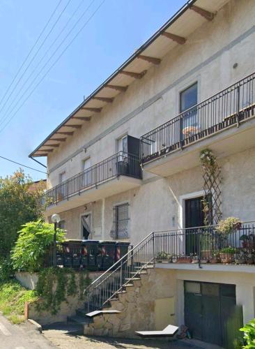 a building with stairs and balconies on the side of it at Narni Come a casa dei nonni in Fiaiola