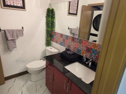 a bathroom with a toilet and a sink and a mirror at Breath-Taking-View-5 Guest DTskyline 18th Floor in Calgary