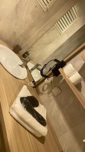 a bathroom with a sink and a toilet in a room at Ay suit in Esenyurt