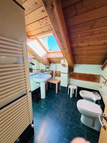 a bathroom with a sink and a toilet and a sink at Residence Cianfuran in Bardonecchia