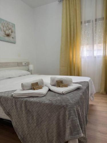 a bedroom with a bed with towels on it at Alojamiento Baeza- El Limonero A in Baeza