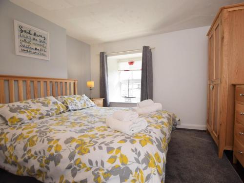 a bedroom with a bed with towels on it at 1 Bed in Seahouses oc-cn123 in Seahouses