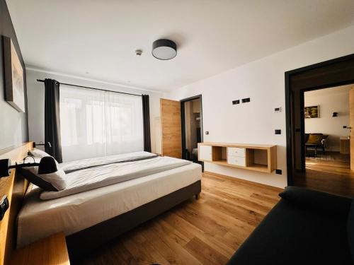 a bedroom with a bed and a large window at NORDIC Apartamente Păltiniș in Păltiniş