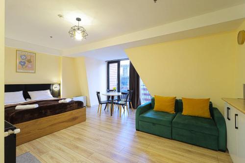 a bedroom with a bed and a couch and a table at Comfy Studio in Gudauri Marshall - By Wehost in Gudauri