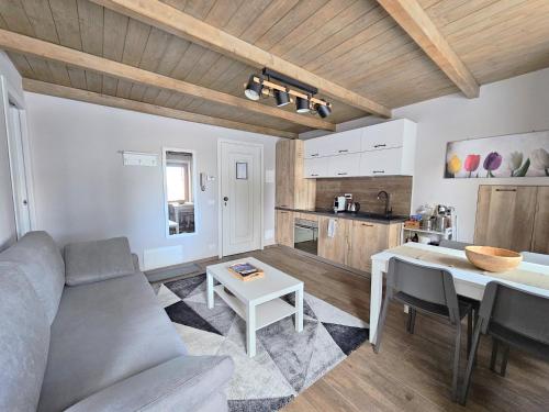 a living room with a couch and a table at Moda Apartments G1 in Sestriere