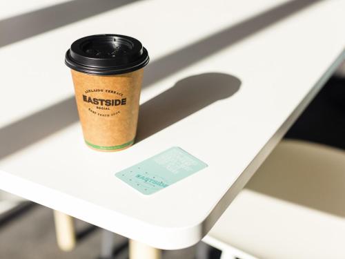 a cup of coffee sitting on a white table at ibis Styles East Perth in Perth