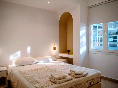 a bedroom with a bed with towels on it at Eva Ivoni apartments in Amoudara Herakliou