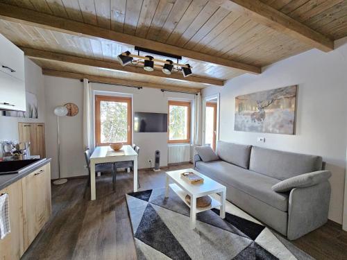 a living room with a couch and a table at Moda Apartments G1 in Sestriere