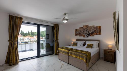 a bedroom with a bed and a large window at Villa Juma by Villas Guide in Blace