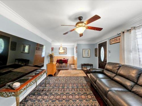 a living room with a couch and a ceiling fan at Oasis of Atlanta in Atlanta