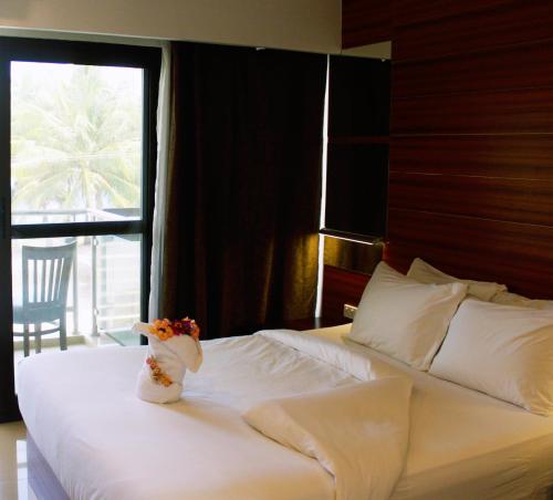 a bedroom with a large white bed with a window at Nambis Inn in Madang