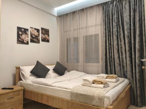 a bedroom with a bed with towels on it at Xryspa suites in Ioannina