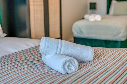 a rolled up towel on top of a bed at 2-BR Near Salford Royal - City & Town Centre View - 1 Minute to Train & Tram Station - Sleeps 6 in Manchester