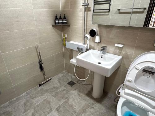 a bathroom with a sink and a toilet at Miru House in Seogwipo