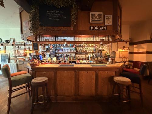 a bar in a restaurant with stools at Great Malvern Hotel in Great Malvern