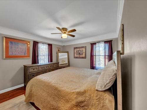 a bedroom with a bed and a ceiling fan at Oasis of Atlanta in Atlanta