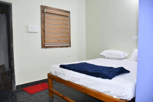a bed in a room with a window at Golden Kudle Beach Resort in Gokarna