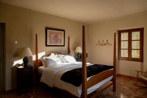 a bedroom with a large bed with four posts at The Winemaker's House - La Collina La Casa in Casa Berta