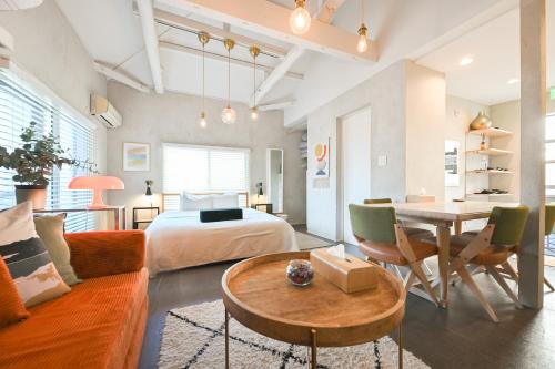 a bedroom with a bed and a table in a room at 846 apartment in Tokyo