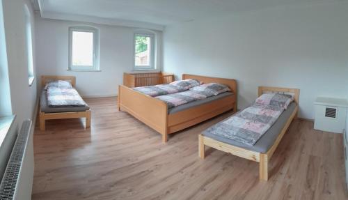 a room with two beds and a bench in it at Ferienhaus Koenig in Kulmain