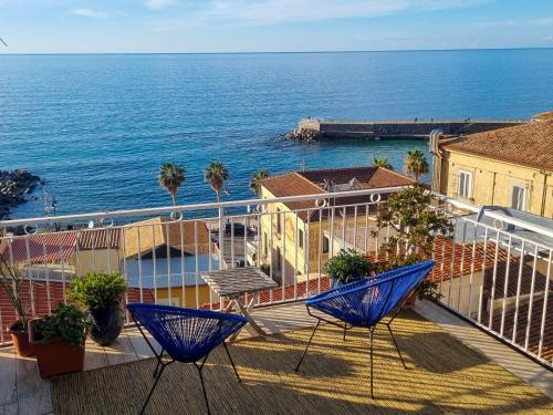 a balcony with two blue chairs and the ocean at Casa Azzurra in Pizzo