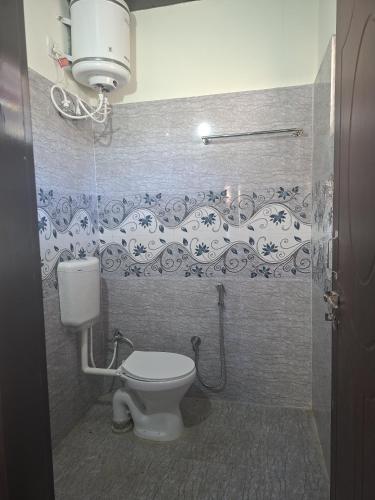a bathroom with a toilet and a shower stall at Mount view guest house in Mukteshwar