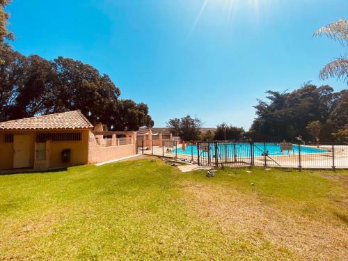 a large yard with a pool and a fence at Maison en corse in Santa-Maria-Poggio