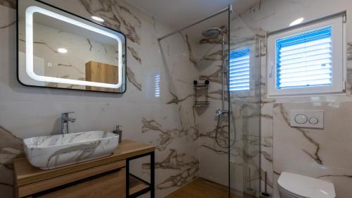 a bathroom with a sink and a shower at Villa Olea by Villas Guide in Blace