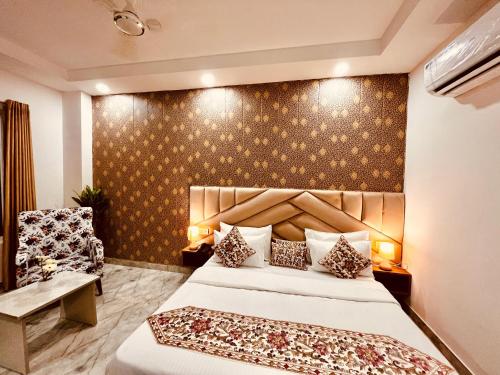 a hotel room with a bed and a chair at Hotel La Meridian, A Four Star Luxury Hotel & Resort - Haridwar in Haridwār