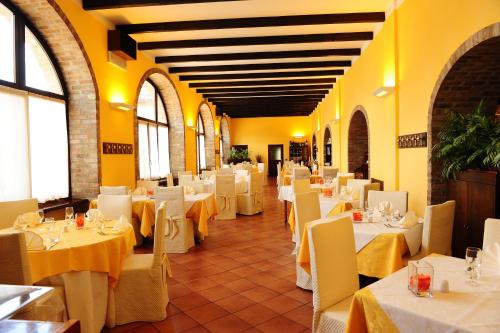 a dining room with white tables and white chairs at Il Carrettino Country Hotel in Tortona
