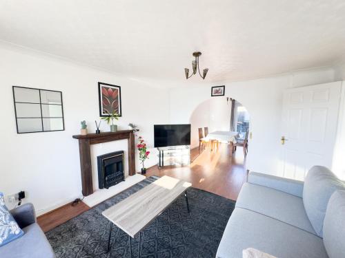 a living room with a couch and a fireplace at Spacious Newport Home Near ICC & Local Attractions in Newport